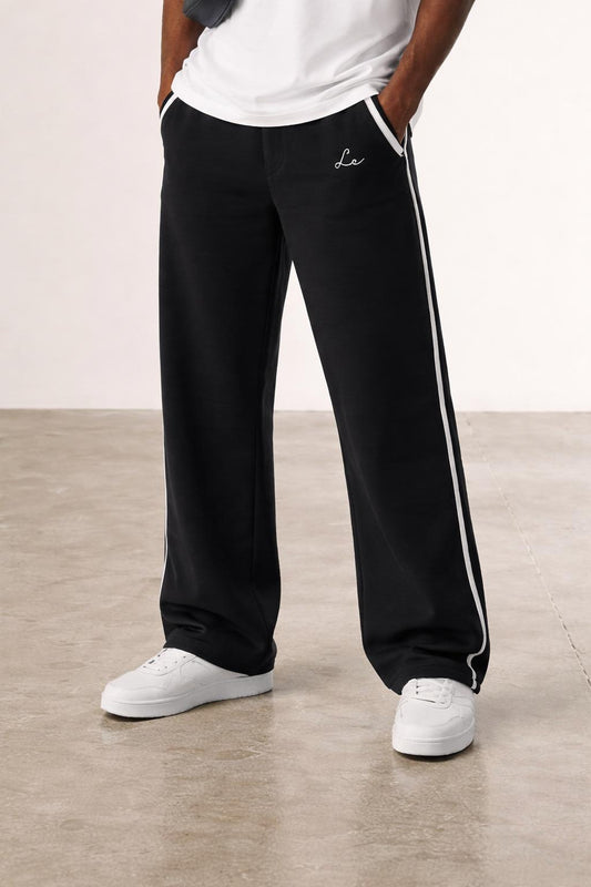 Close-up of the model's lower body wearing The Lounge Rest Trousers